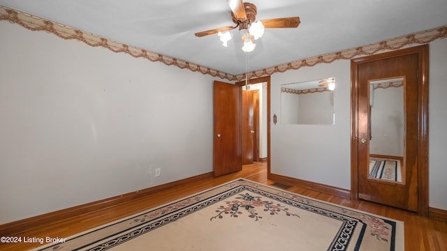 unfurnished room with light wood-type flooring and ceiling fan