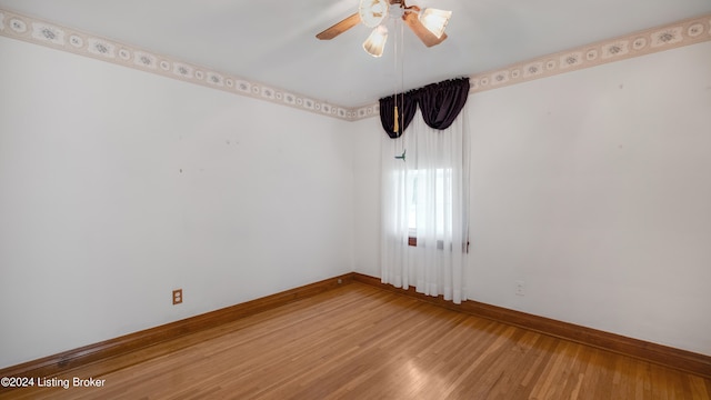 spare room featuring wood-type flooring and ceiling fan