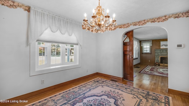 dining space featuring a textured ceiling, hardwood / wood-style flooring, and a fireplace