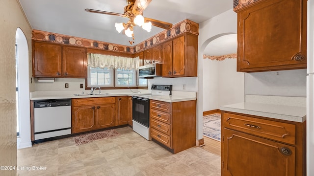 kitchen featuring sink, white appliances, and ceiling fan