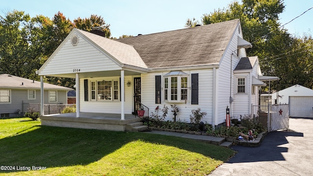 view of front facade featuring an outdoor structure, a front yard, and a garage