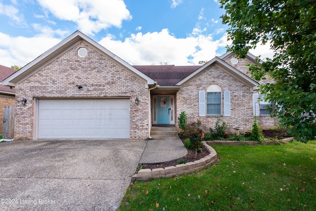 ranch-style home with a front yard and a garage