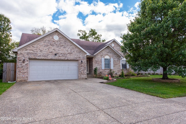 ranch-style house featuring a front lawn and a garage