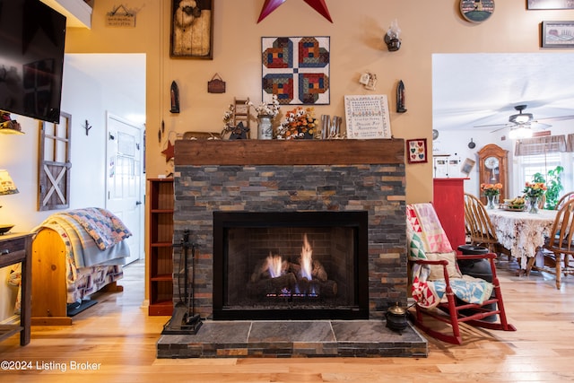 details with ceiling fan, a fireplace, and hardwood / wood-style floors