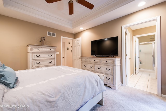 tiled bedroom with ceiling fan, ornamental molding, and a tray ceiling