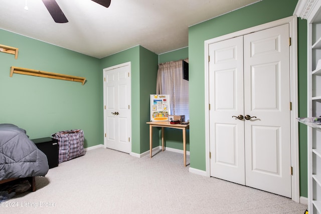 carpeted bedroom featuring a closet and ceiling fan