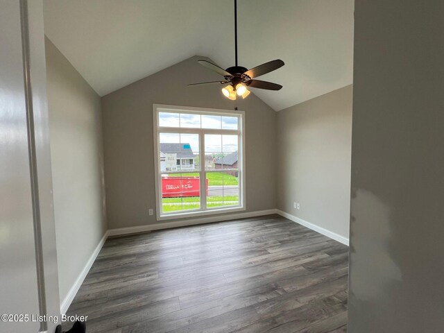 unfurnished room with a ceiling fan, lofted ceiling, wood finished floors, and baseboards