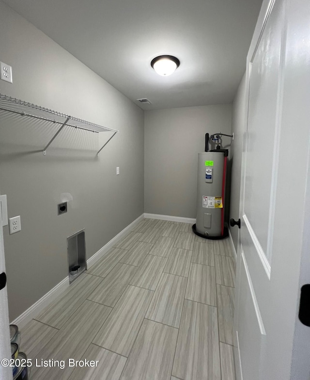 laundry area featuring water heater, laundry area, electric dryer hookup, baseboards, and wood tiled floor