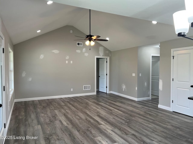 spare room with dark wood finished floors, visible vents, a ceiling fan, and baseboards