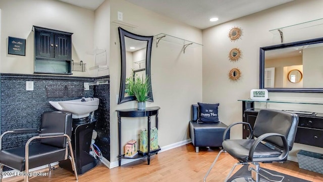 bathroom with tile walls and hardwood / wood-style floors