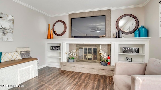 living room featuring crown molding, dark wood-type flooring, a fireplace, and ceiling fan