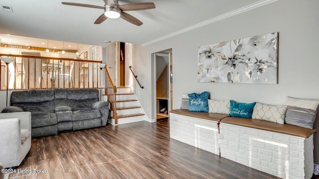 living room featuring ornamental molding, hardwood / wood-style flooring, and ceiling fan