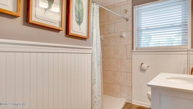 bathroom featuring vanity, toilet, curtained shower, and hardwood / wood-style floors