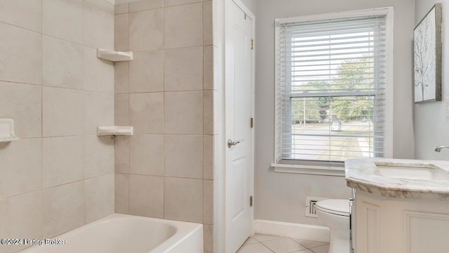 bathroom with toilet, vanity, and tile patterned flooring