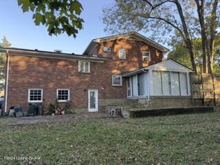 rear view of property with a yard