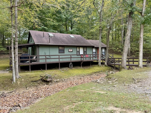 308 Oak Rd, Falls Of Rough, KY 40119 - view of front of house featuring a deck, roof with shingles, and a forest view