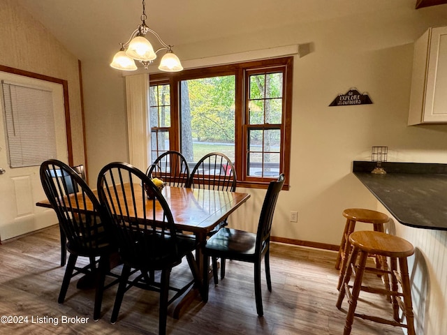 308 Oak Rd, Falls Of Rough, KY 40119 - dining area featuring lofted ceiling, a notable chandelier, and wood-type flooring
