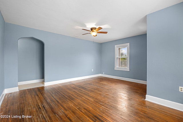 spare room featuring ceiling fan and dark hardwood / wood-style flooring