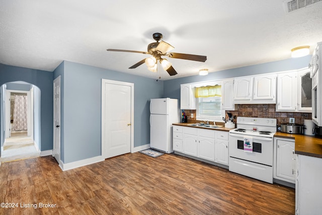 kitchen with white cabinets, white appliances, dark hardwood / wood-style floors, and ceiling fan