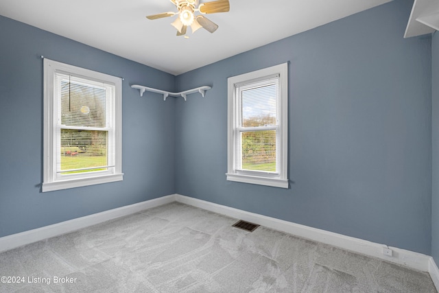 spare room with light colored carpet and ceiling fan