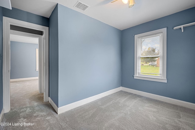 spare room with ceiling fan and carpet flooring