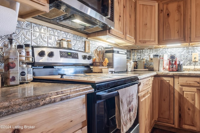 kitchen featuring backsplash and stainless steel appliances