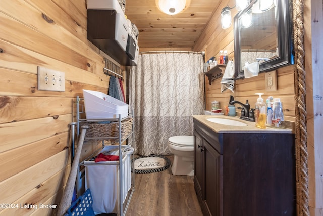 bathroom with vanity, wood walls, wood finished floors, toilet, and wooden ceiling