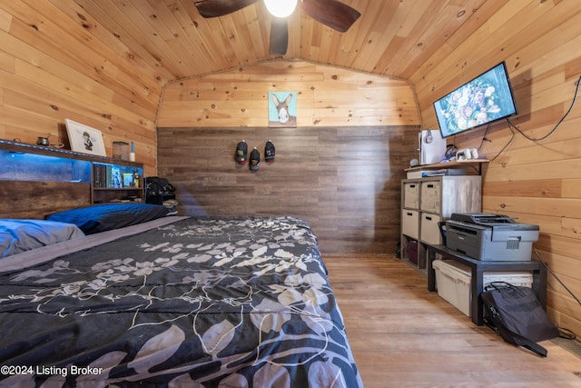 bedroom featuring wood finished floors, wood ceiling, lofted ceiling, and wooden walls