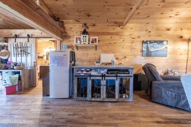 interior space with wooden ceiling, wood walls, and wood finished floors