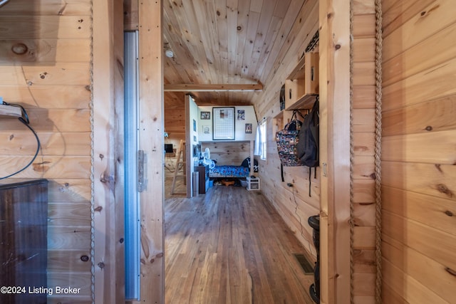 corridor with wood ceiling, wood walls, hardwood / wood-style floors, and visible vents