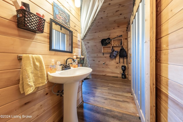 bathroom featuring wooden walls and wood finished floors