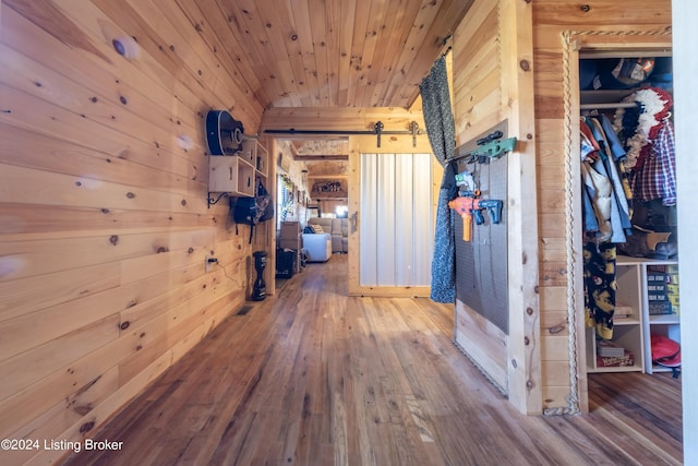 corridor with wood ceiling, wood-type flooring, and wood walls