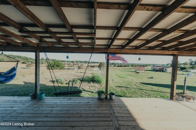 wooden deck featuring a yard and a rural view