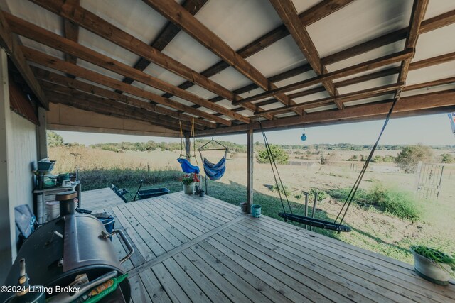 wooden deck with a boat dock and a rural view