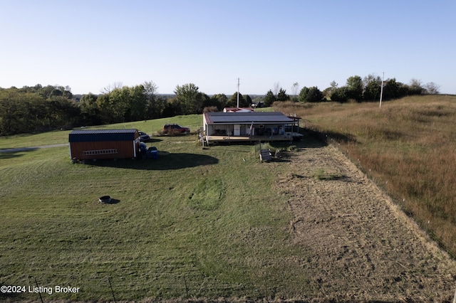 view of yard featuring driveway and a rural view