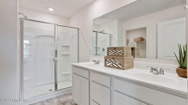 bathroom featuring vanity, wood-type flooring, and an enclosed shower