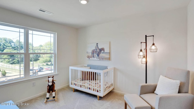 carpeted bedroom with a crib