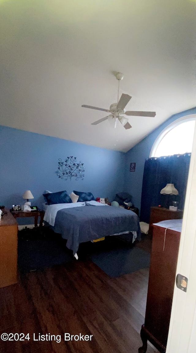 bedroom with ceiling fan and dark hardwood / wood-style flooring