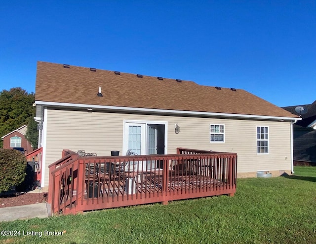 back of house featuring a wooden deck and a yard