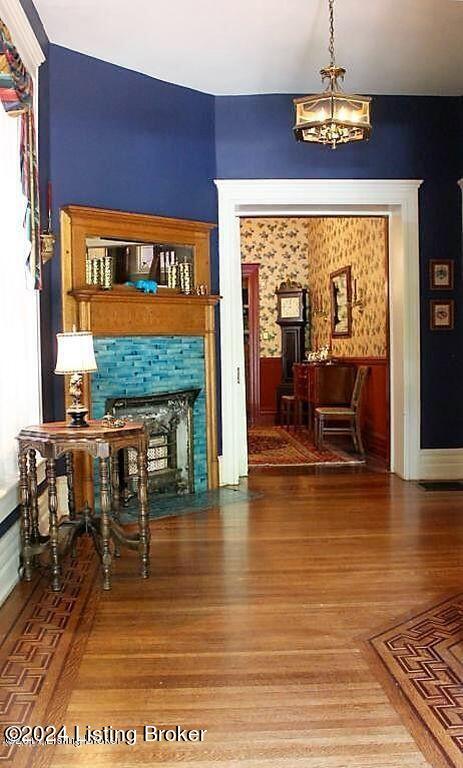 interior space with a chandelier and hardwood / wood-style flooring