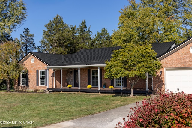 view of front of house with a garage, a front lawn, and a porch