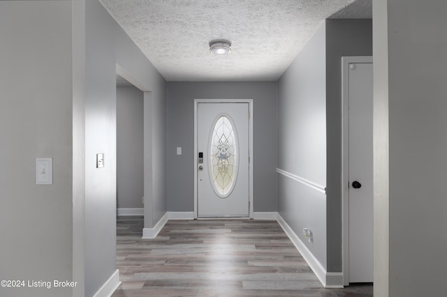 entryway featuring a textured ceiling and light wood-type flooring