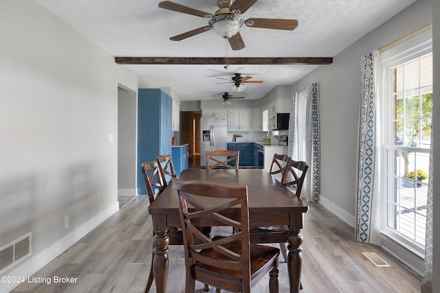 dining room with ceiling fan, a textured ceiling, and light hardwood / wood-style flooring