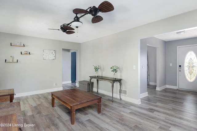 living room with light hardwood / wood-style flooring and ceiling fan