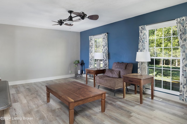 living room with light hardwood / wood-style floors and ceiling fan