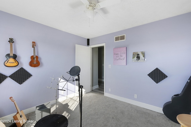 interior space featuring ceiling fan and light colored carpet