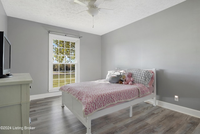 bedroom featuring ceiling fan, a textured ceiling, and hardwood / wood-style floors