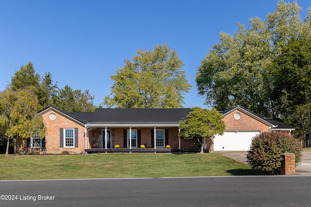 ranch-style house featuring a front yard, a porch, and a garage