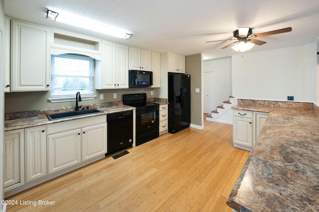 kitchen with black appliances, white cabinets, sink, ceiling fan, and light hardwood / wood-style floors