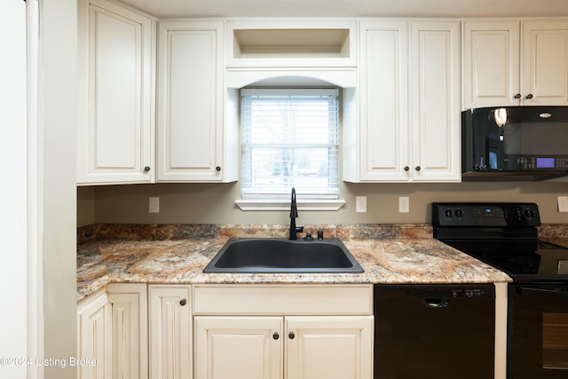 kitchen featuring sink, white cabinetry, and black appliances